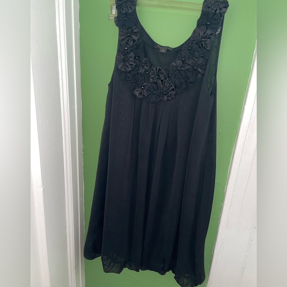 Black cocktail dress with floral appliqué